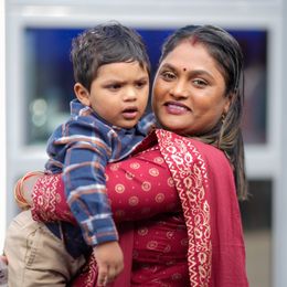 A mother carrying her child