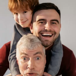 A grandfather, his son and his grandson, laughing