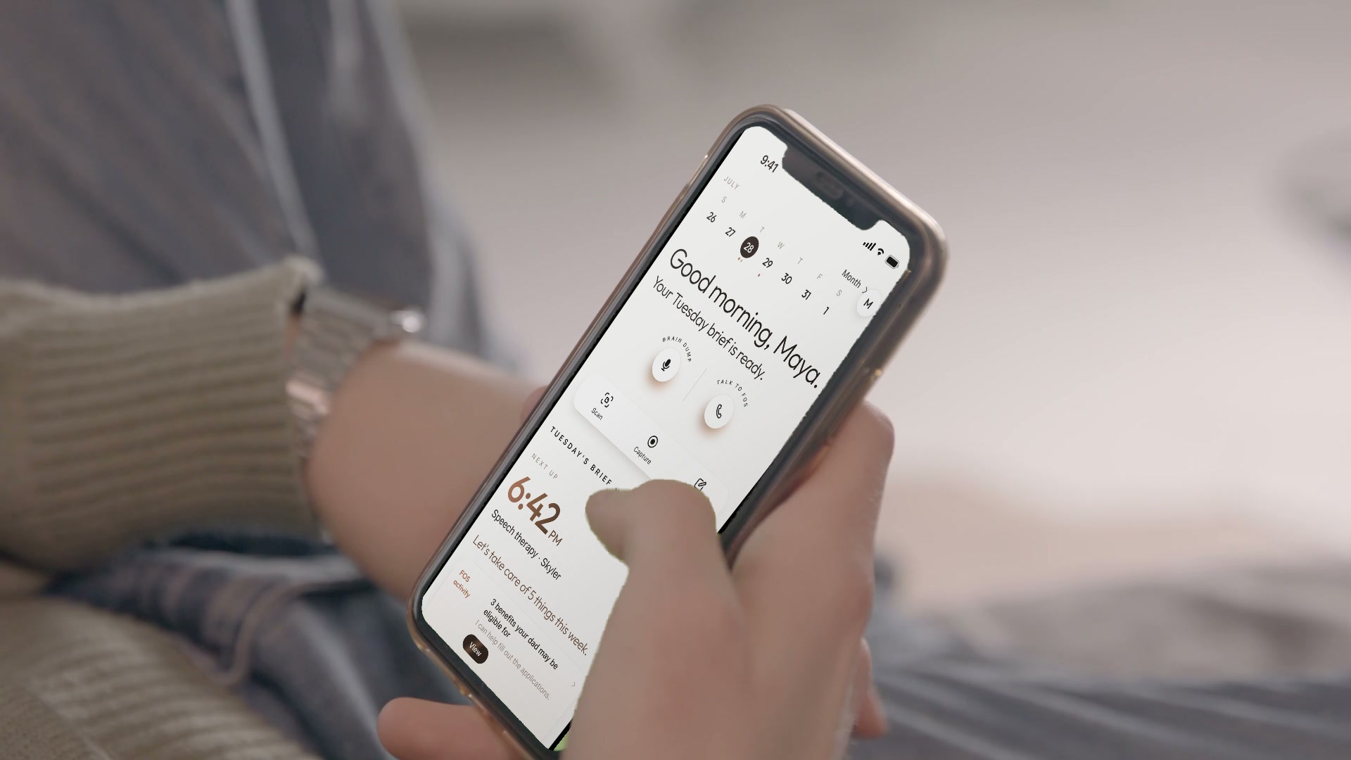 The FOS app open on a phone held in someone&rsquo;s hands